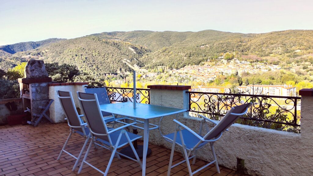Outdoor dining area on the private terrace with a panoramic mountain view