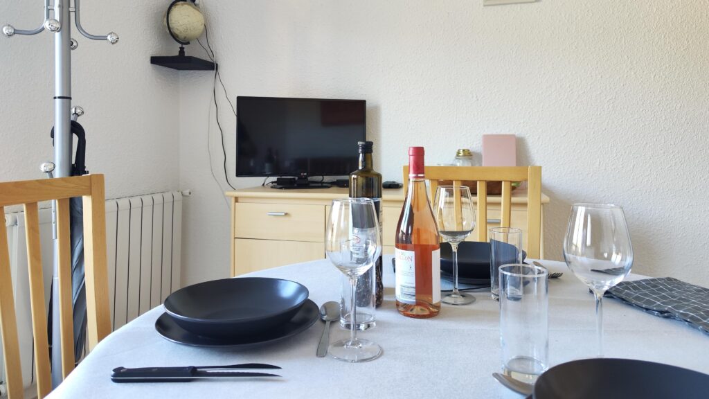 Living room with dining table, television and storage