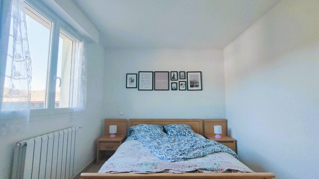 Bedroom window, double bed and storage furniture
