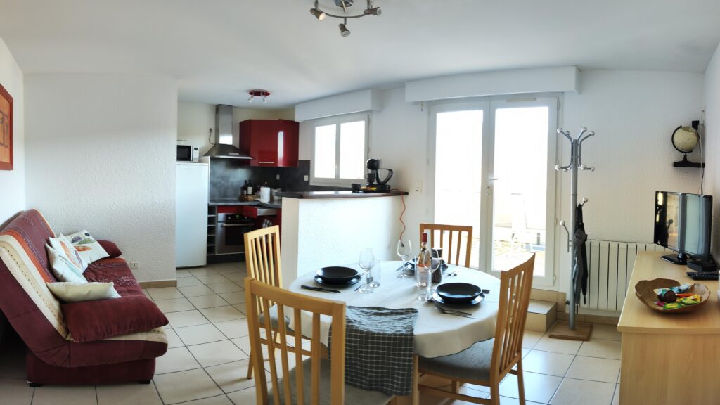 Panoramic living room with sofa bed, dining table and open kitchen